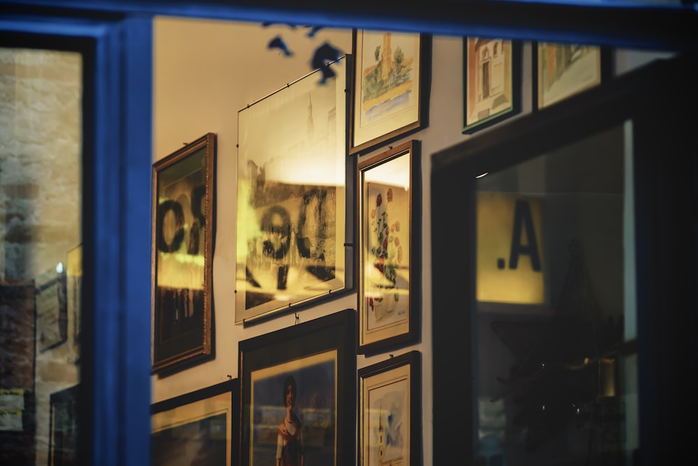 black wooden framed photos on blue wall