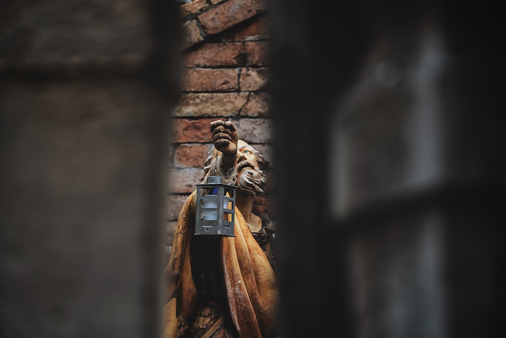 brown and black statue of man