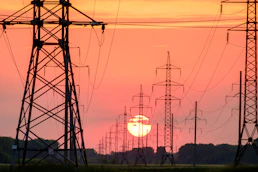 silhouette of electric post during sunset