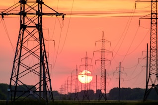 silhouette of electric post during sunset