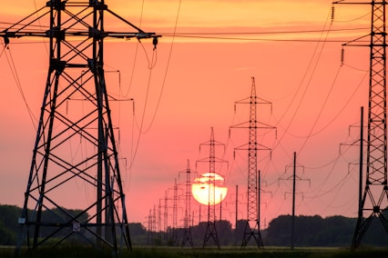 silhouette of electric post during sunset