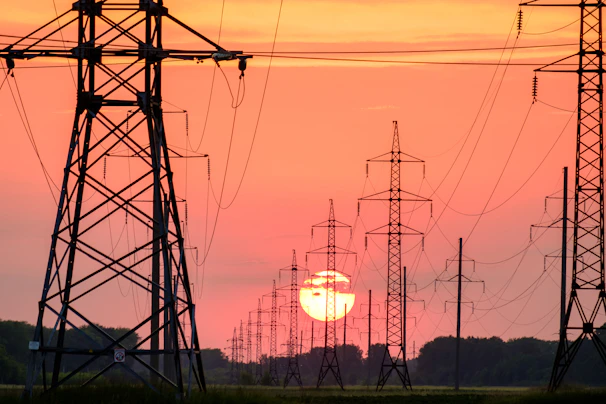 silhouette of electric post during sunset
