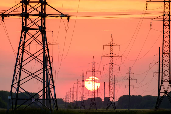 silhouette of electric post during sunset