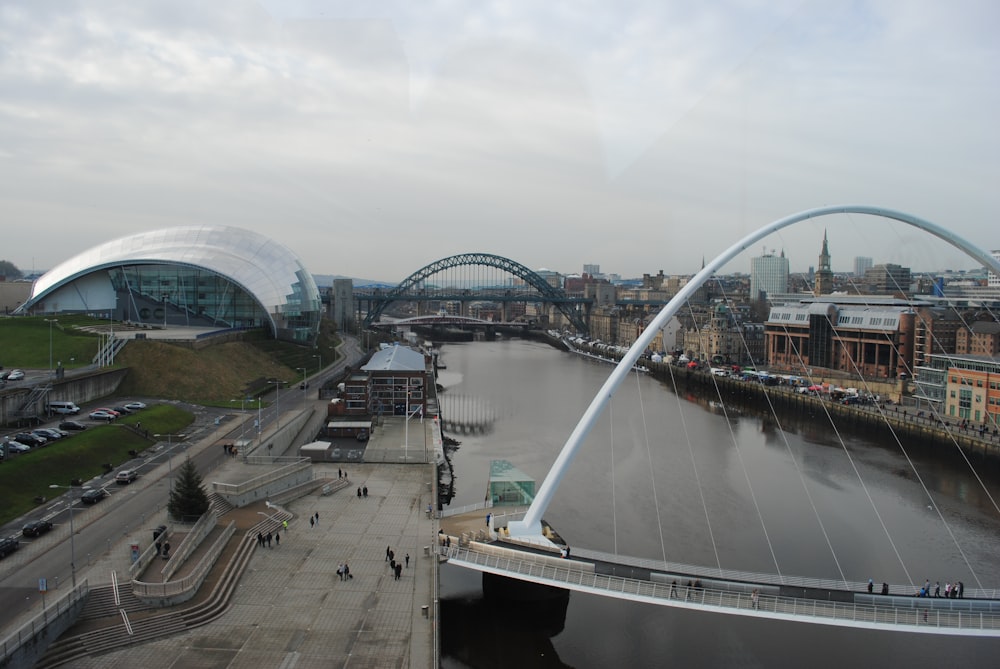 white bridge over river under cloudy sky during daytime