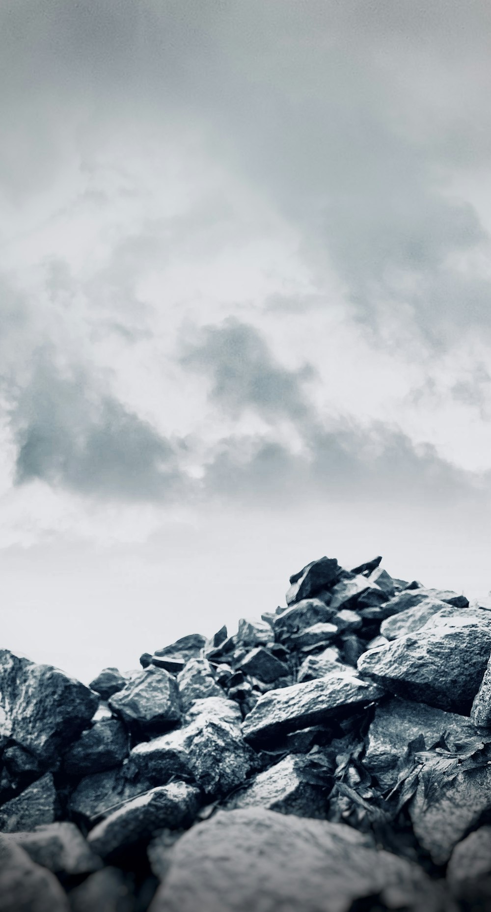 rocky mountain under white clouds during daytime