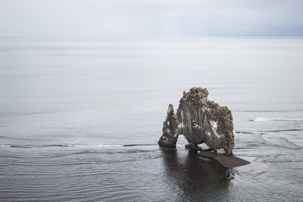 a rock formation in the middle of the ocean