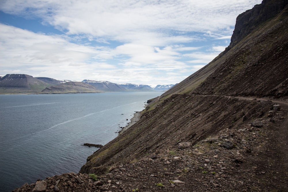 a view of a body of water with mountains in the background