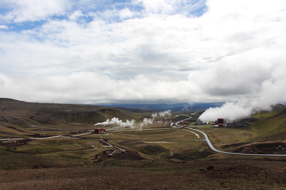 a steam engine train traveling through a rural countryside