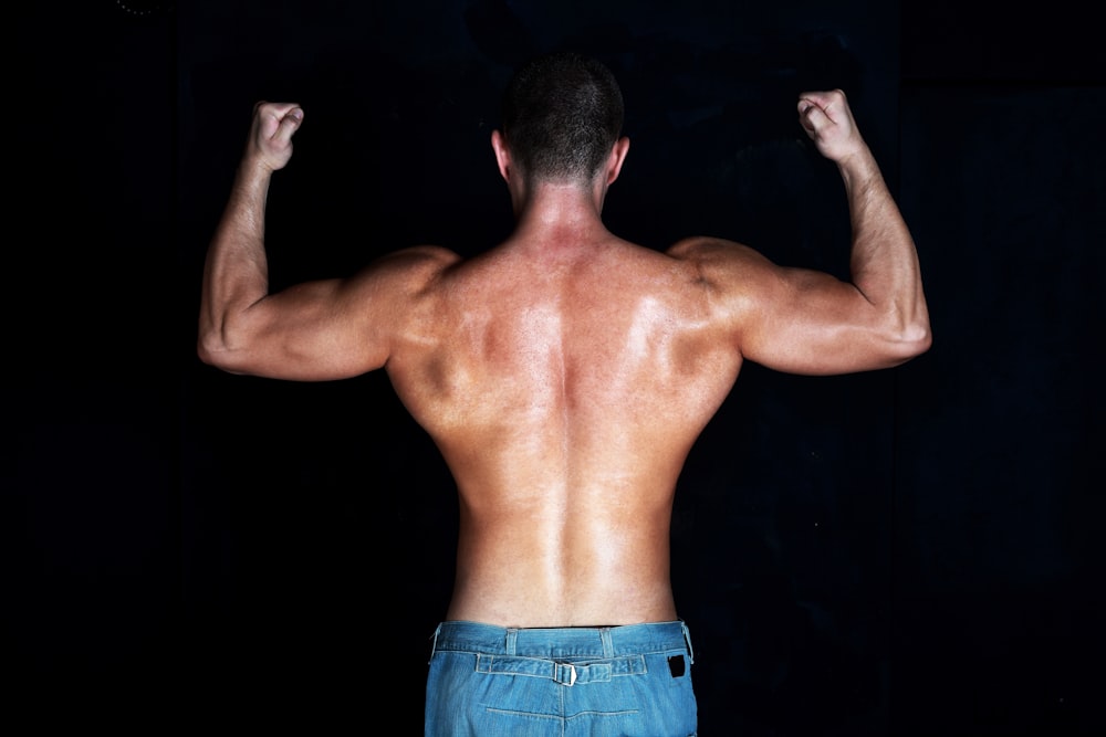 topless man in blue denim bottoms