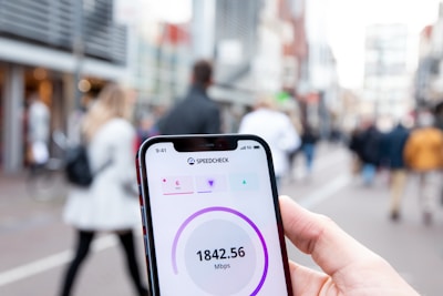 a person holding a cell phone in their hand