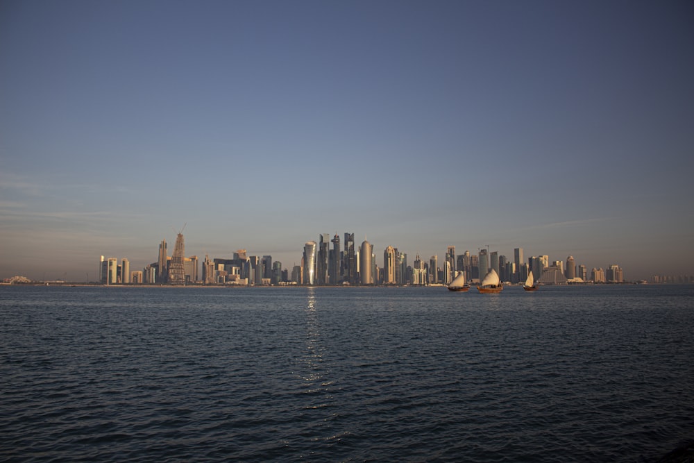 a large body of water with a city in the background