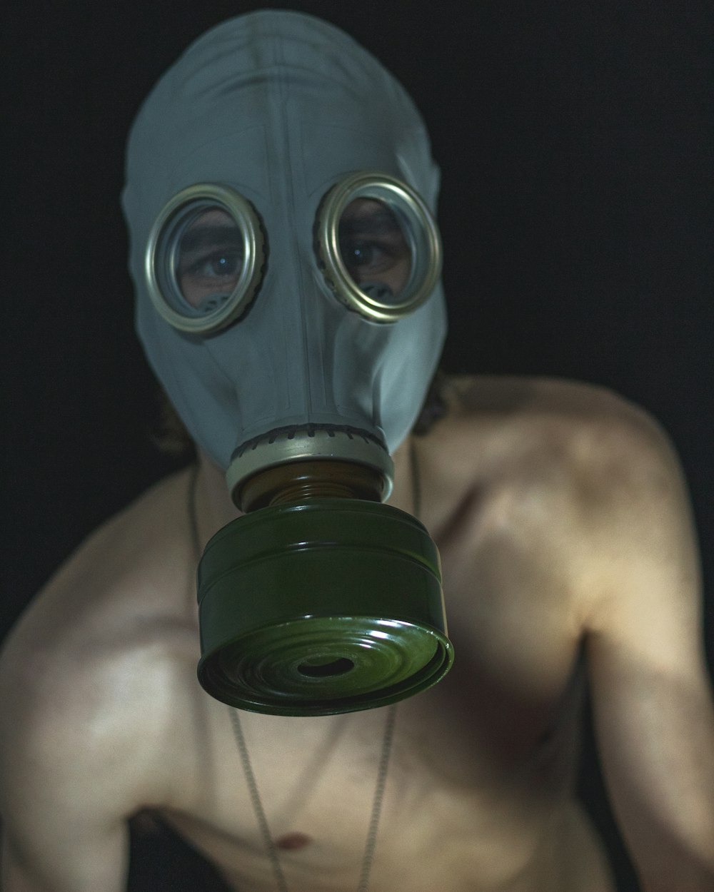 topless man wearing black gas mask