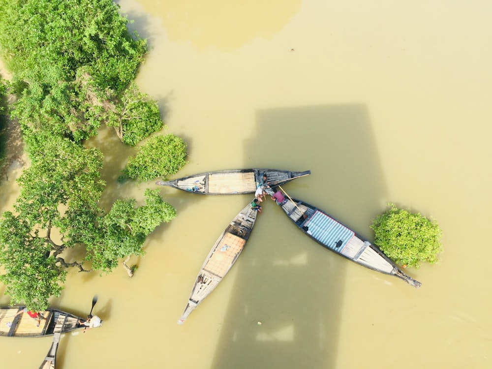 aerial view of blue and white boat on body of water during daytime