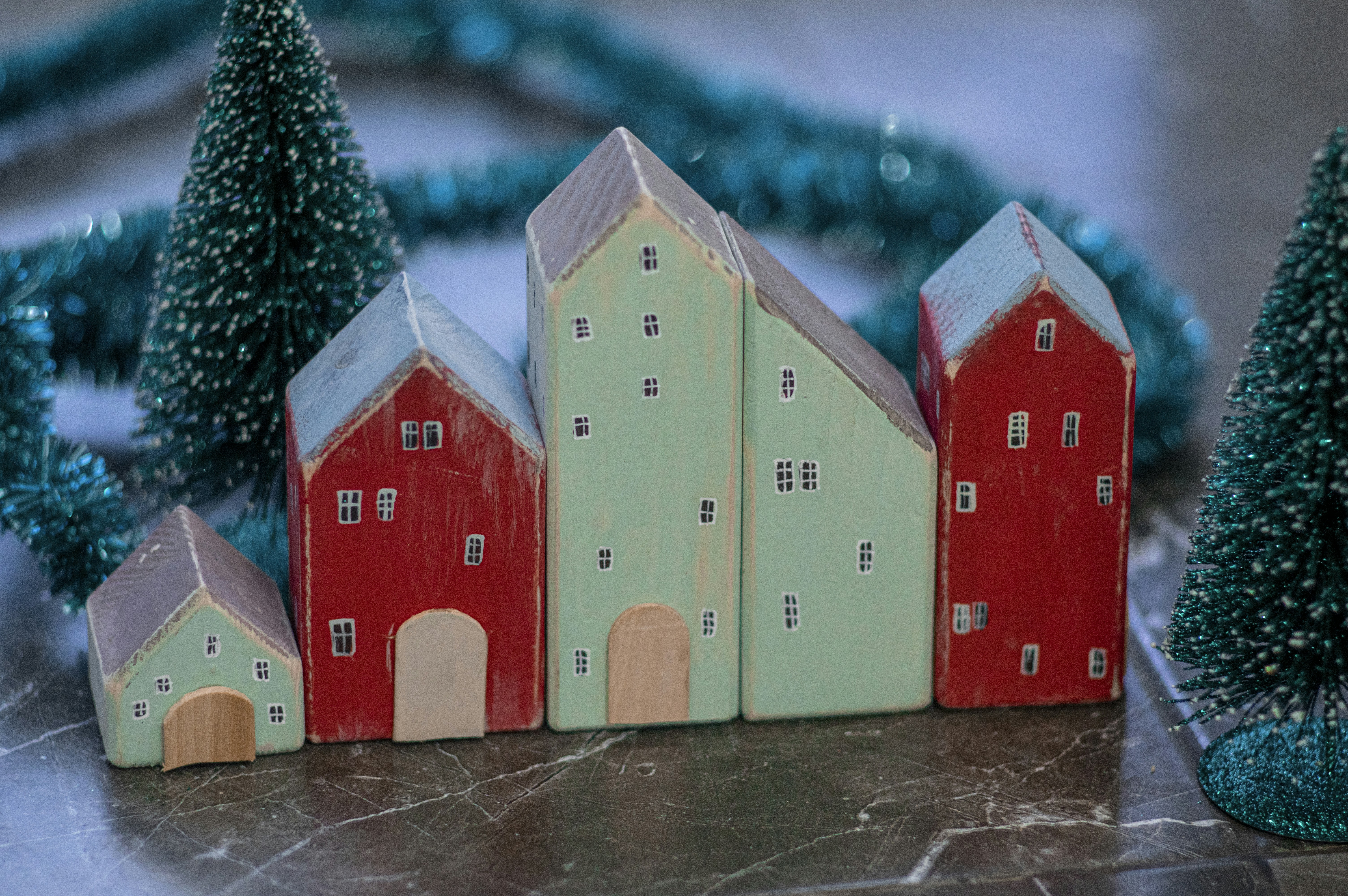 red and white wooden houses under blue sky christmas tree stand teams background