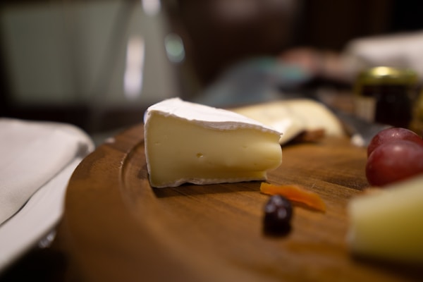 sliced cheese on brown wooden chopping board