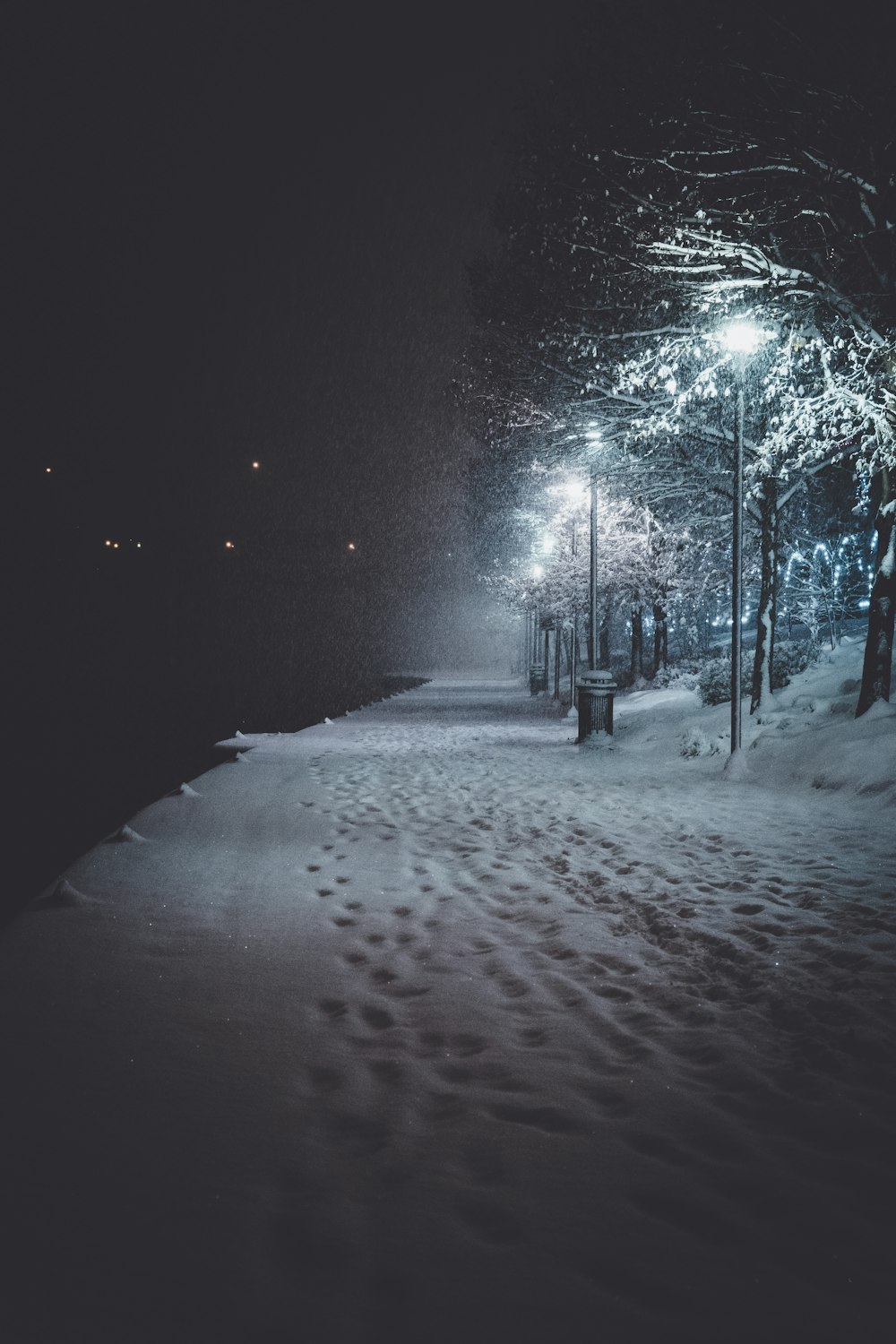 snow covered road during night time