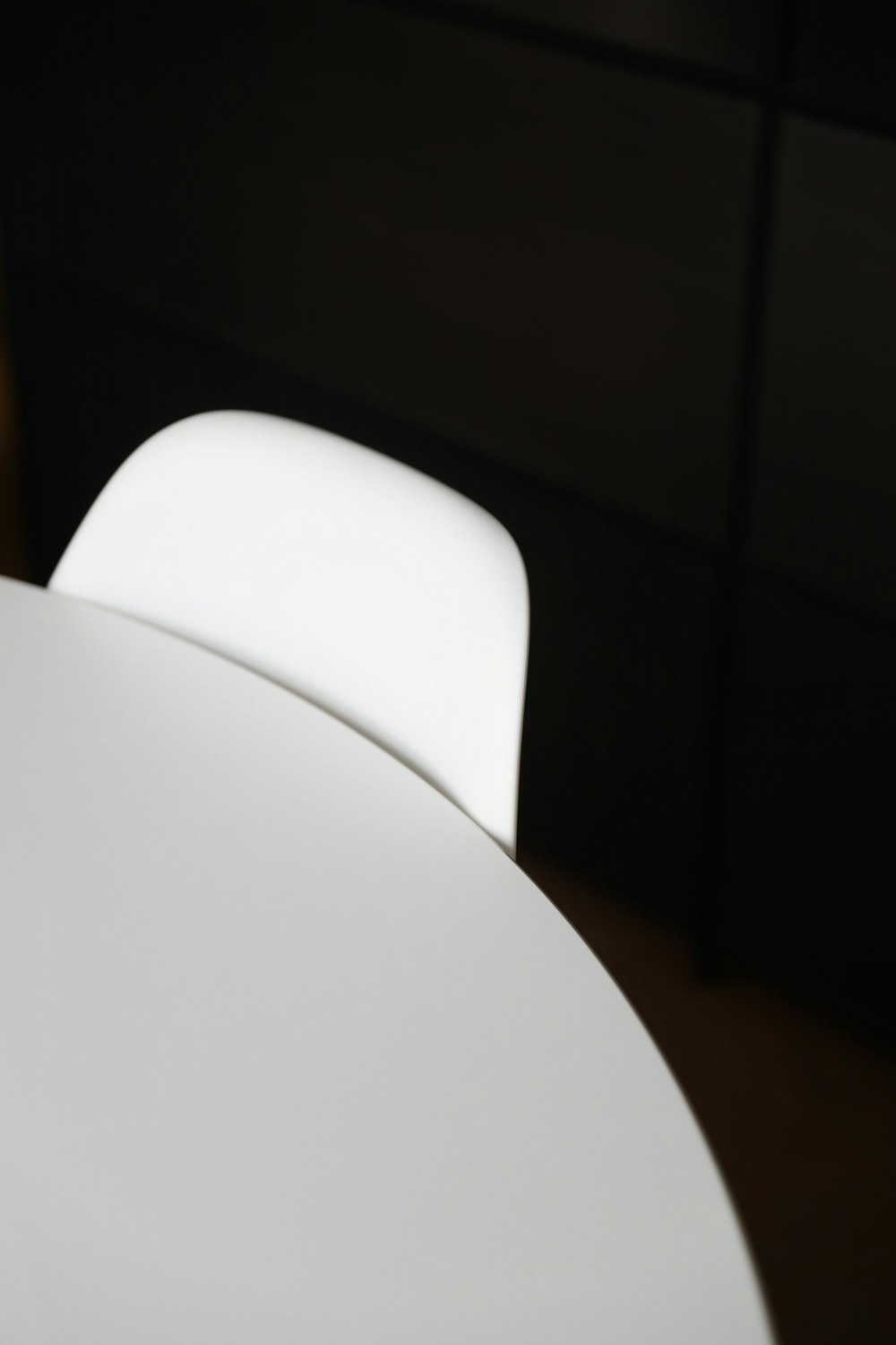 white plastic chair beside white table