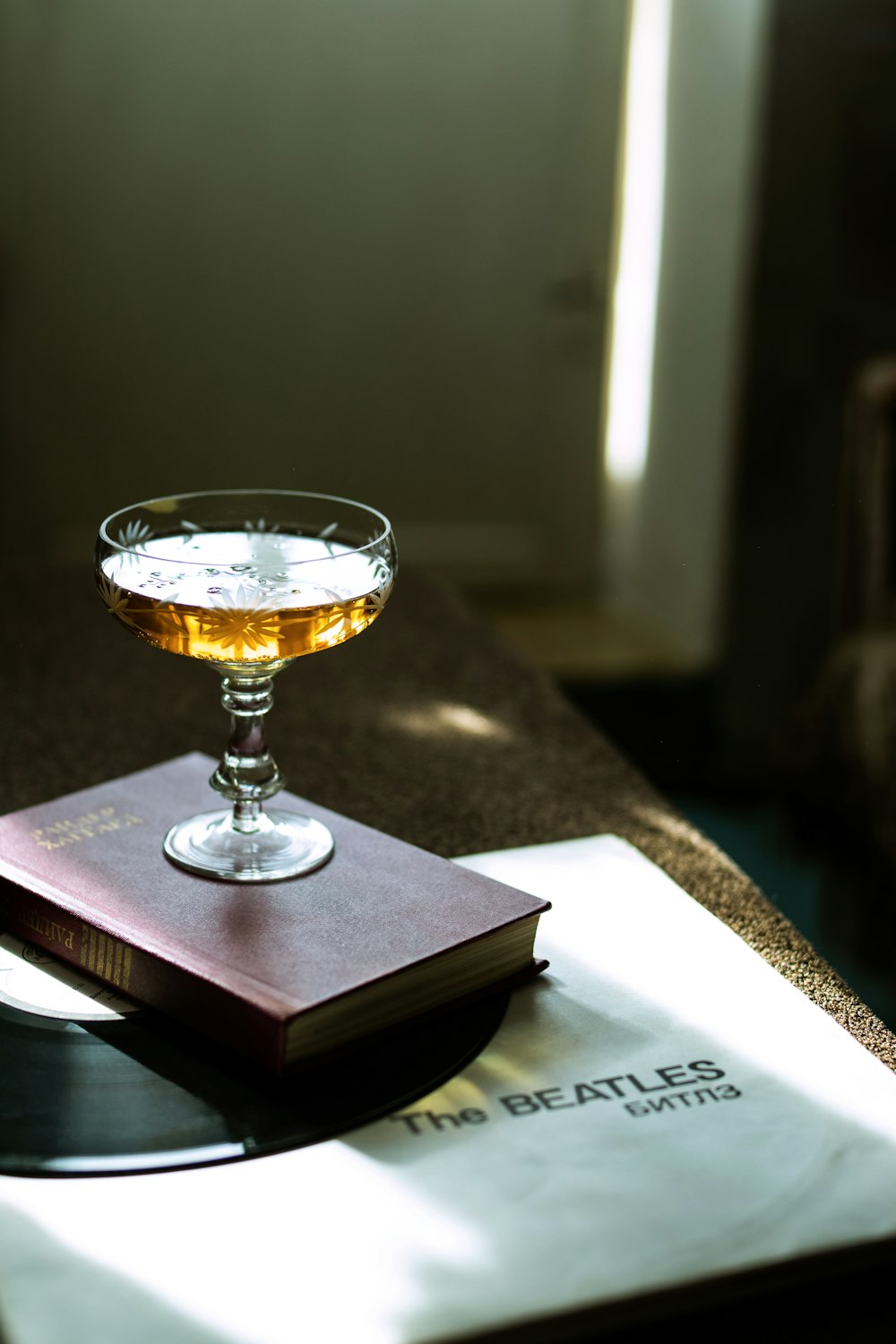 clear wine glass on brown book