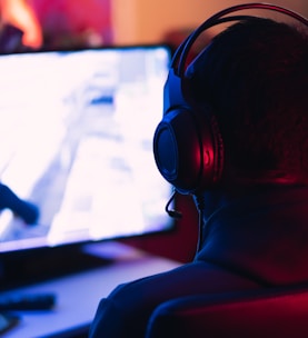 man in red shirt wearing black headphones