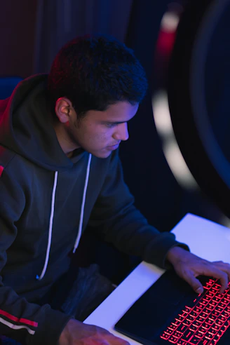 man in gray hoodie writing on white paper