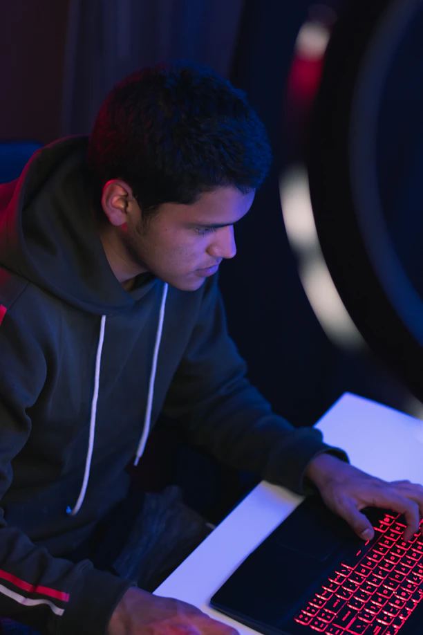 man in gray hoodie writing on white paper