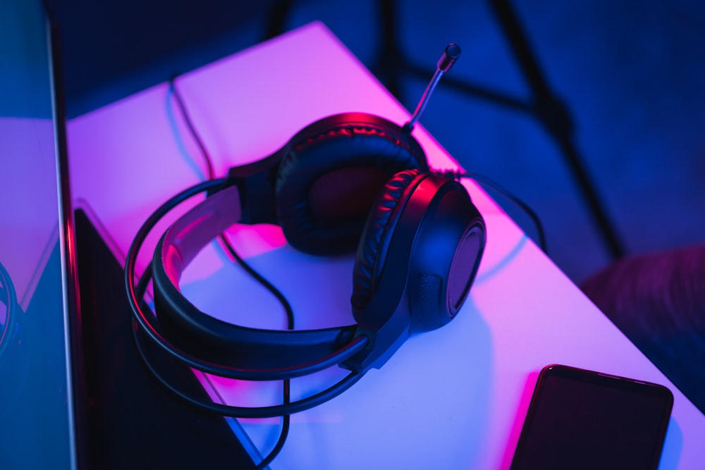 black and red corded headphones on white table