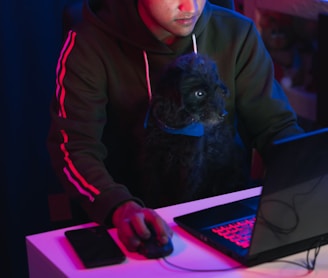 man in gray hoodie using black laptop computer