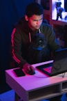 man in gray hoodie using black laptop computer