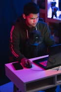 man in gray hoodie using black laptop computer