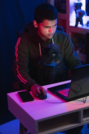 man in gray hoodie using black laptop computer