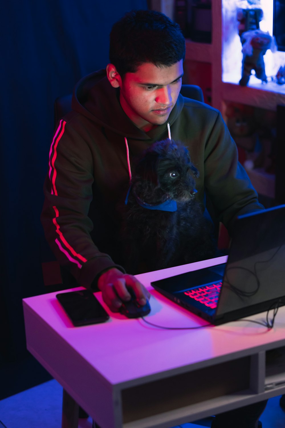 man in gray hoodie using black laptop computer