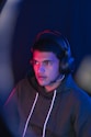 man in blue hoodie wearing black headphones