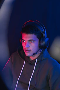 man in blue hoodie wearing black headphones