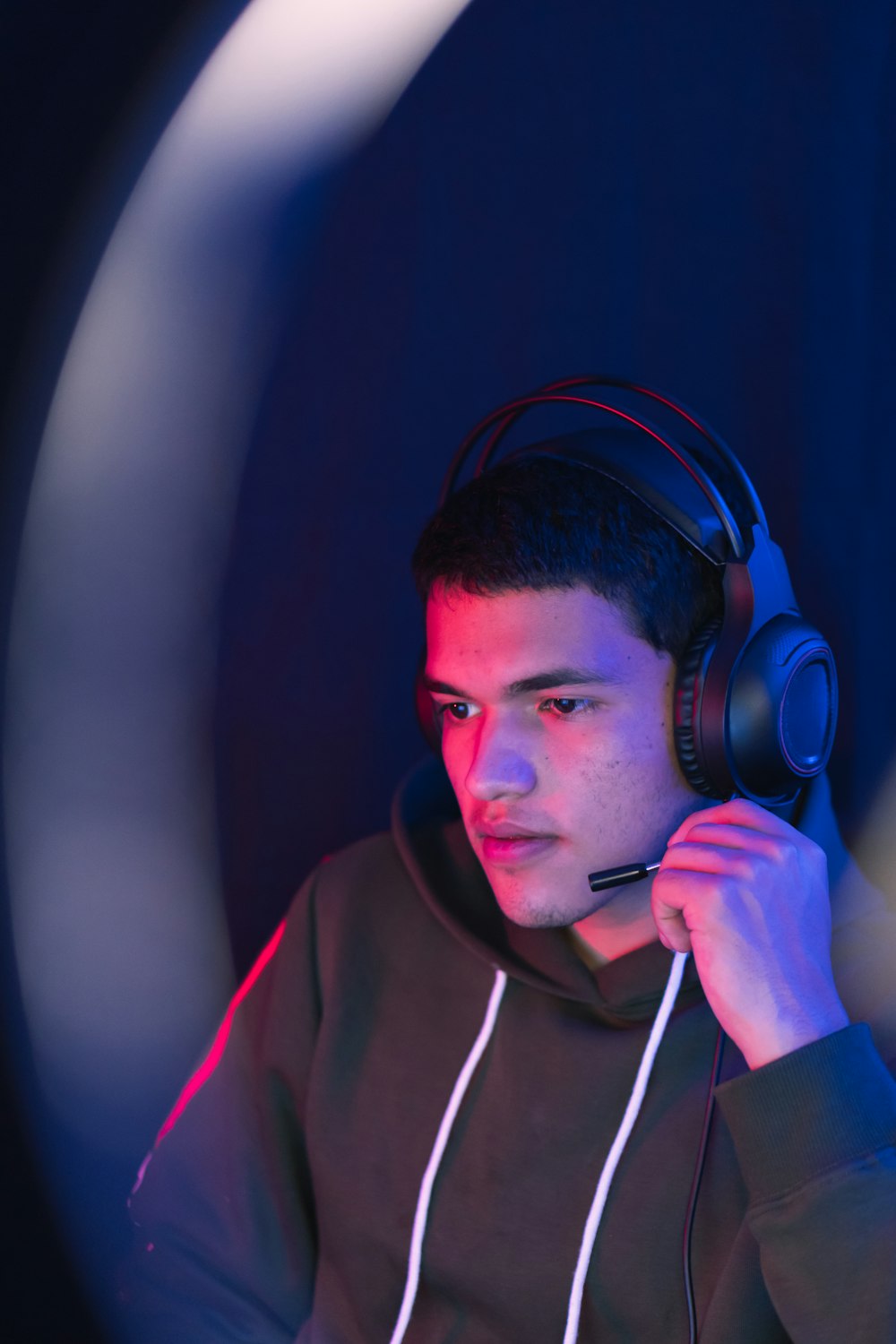 man in red hoodie wearing black headphones