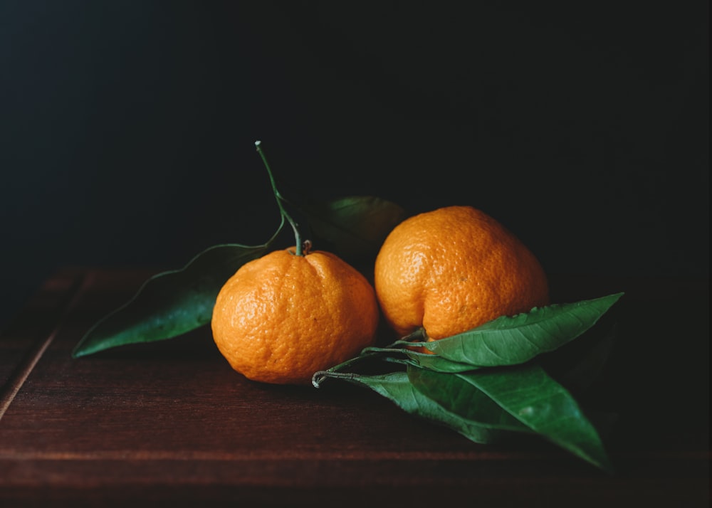 orange fruit on brown wooden table