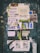 A weathered bulletin board covered with a variety of overlapping paper fliers and posters. The advertisements include rental listings, event notices, and service offers. The papers are in various stages of wear, with some crumpled and others torn. There is visible text in Spanish and a mix of graphics including logos and images. The background is a faded, chipped surface with graffiti around the edges.