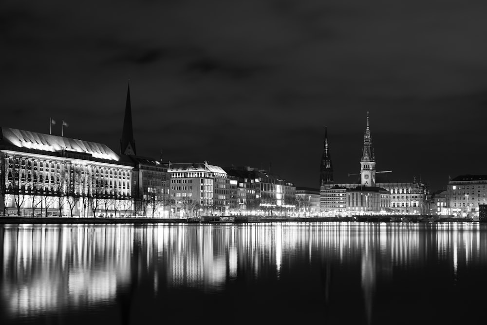 grayscale photo of building near body of water