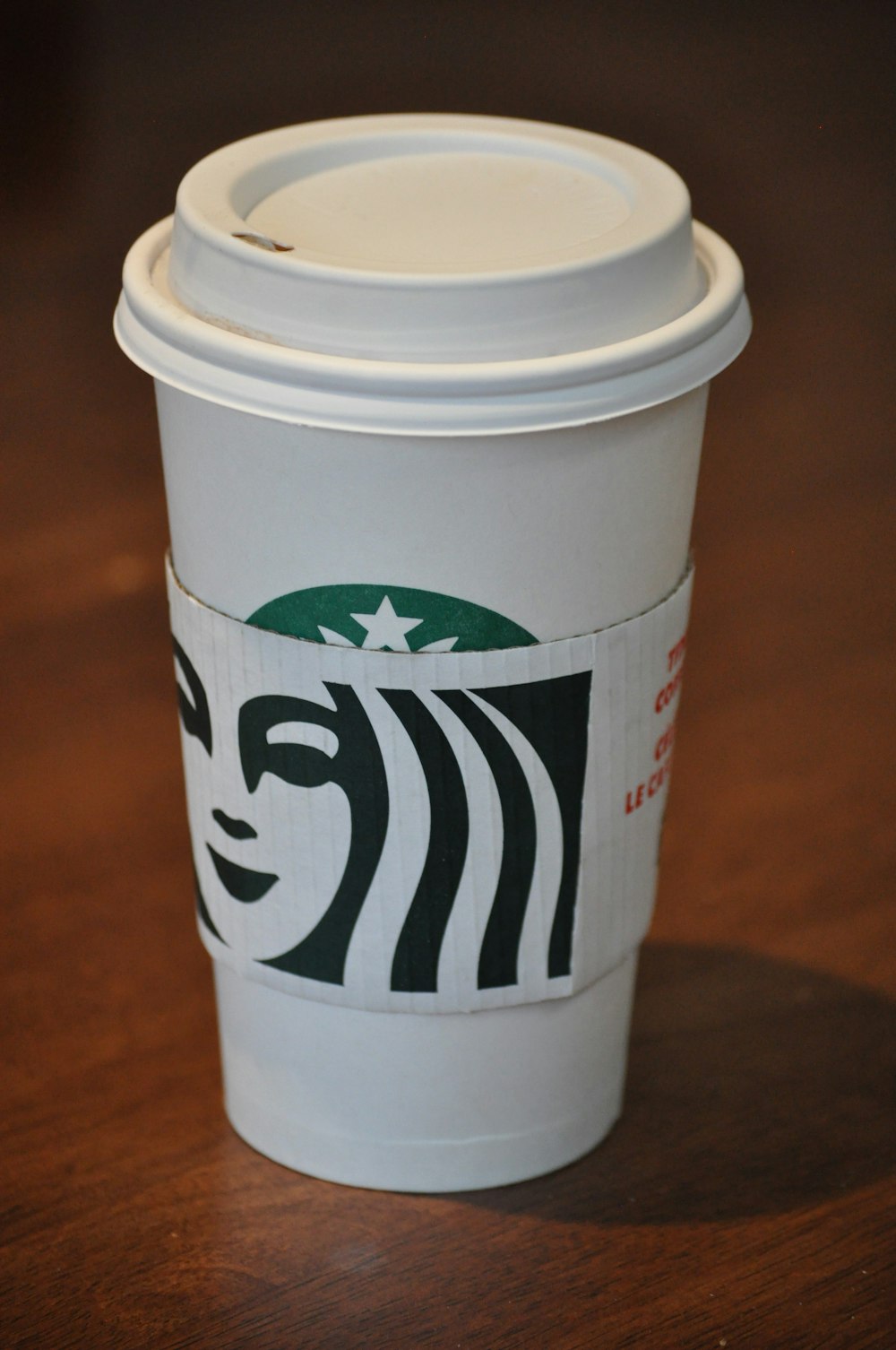 white and green starbucks disposable cup