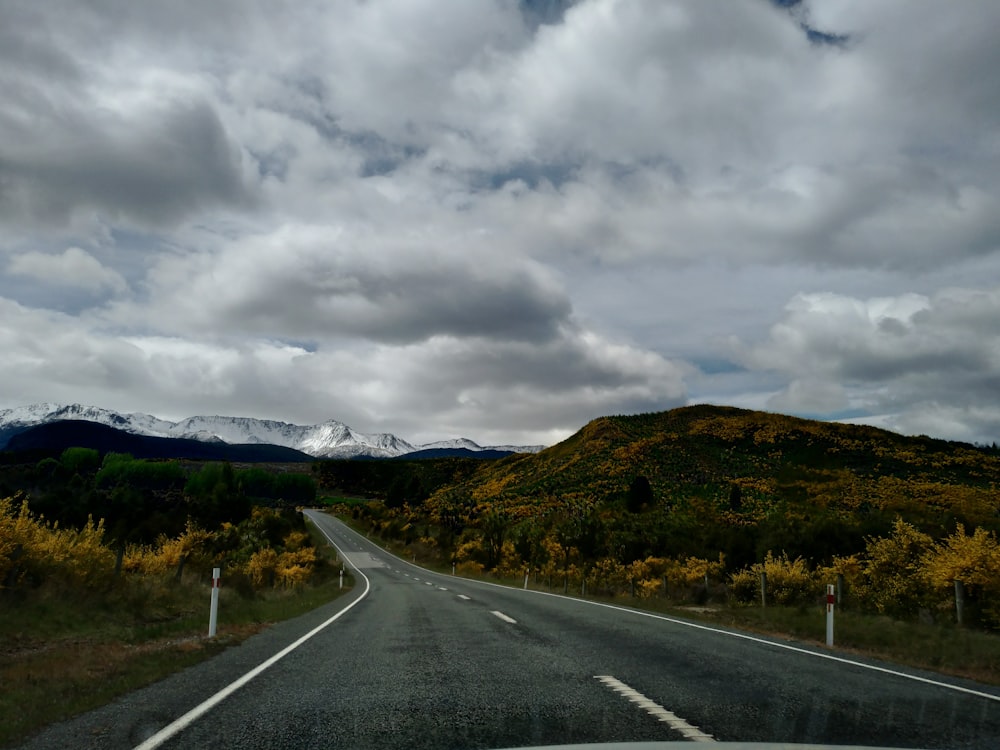 gray concrete road under gray clouds