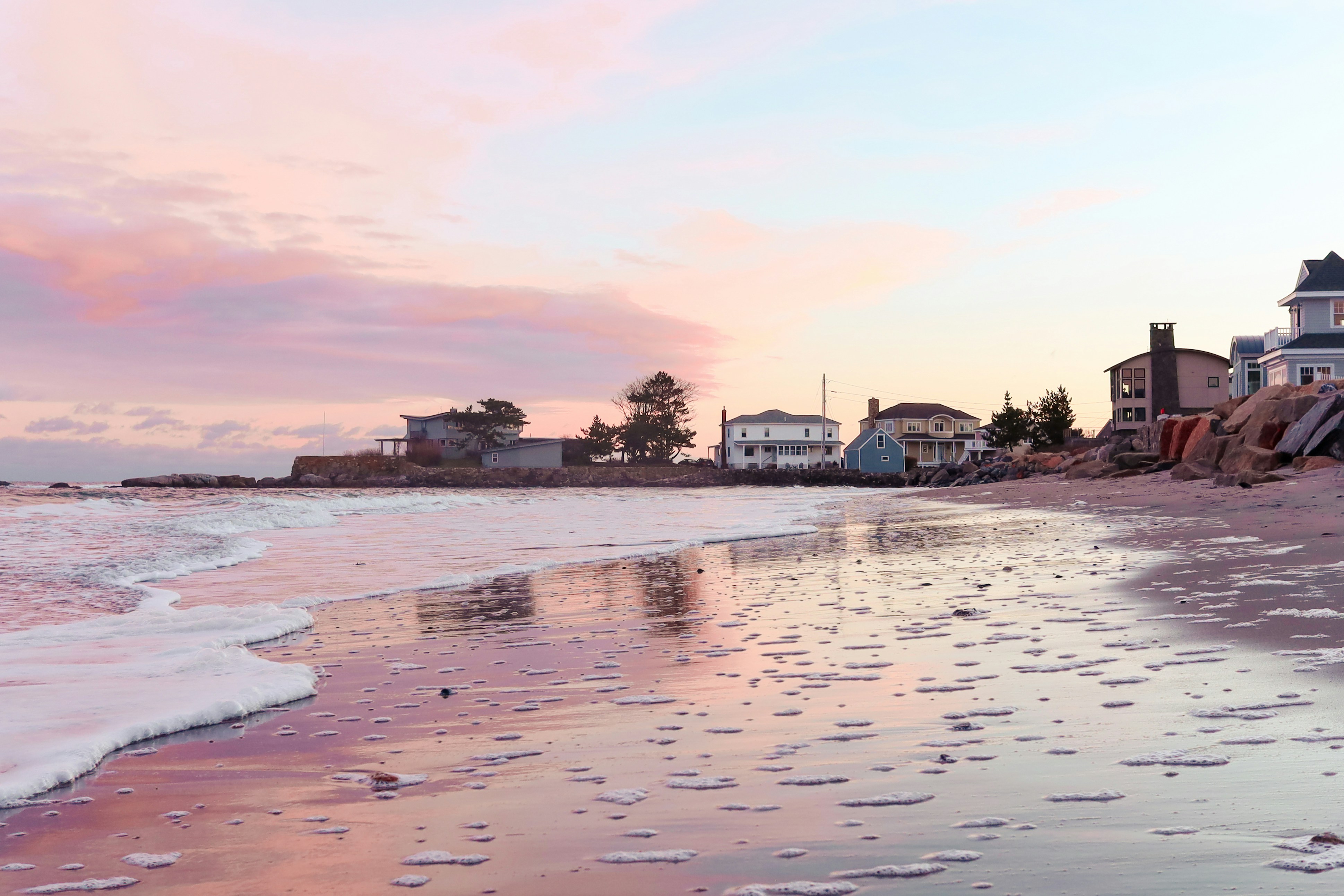 white and black house near body of water during daytime
