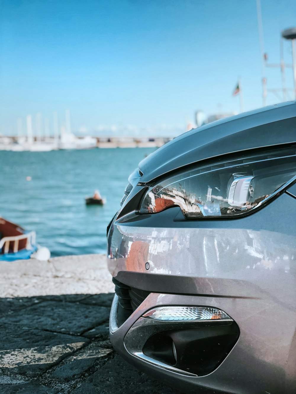 gray car near body of water during daytime