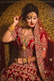 woman in red and gold sari dress