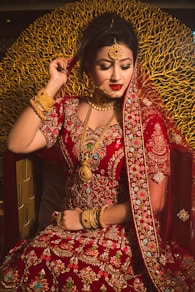 woman in red and gold sari dress
