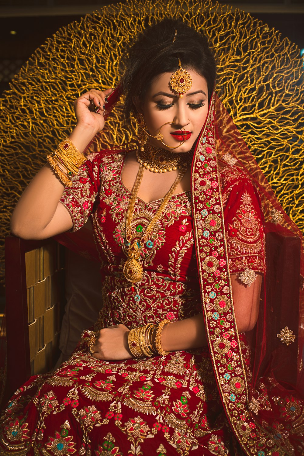 woman in red and gold sari dress