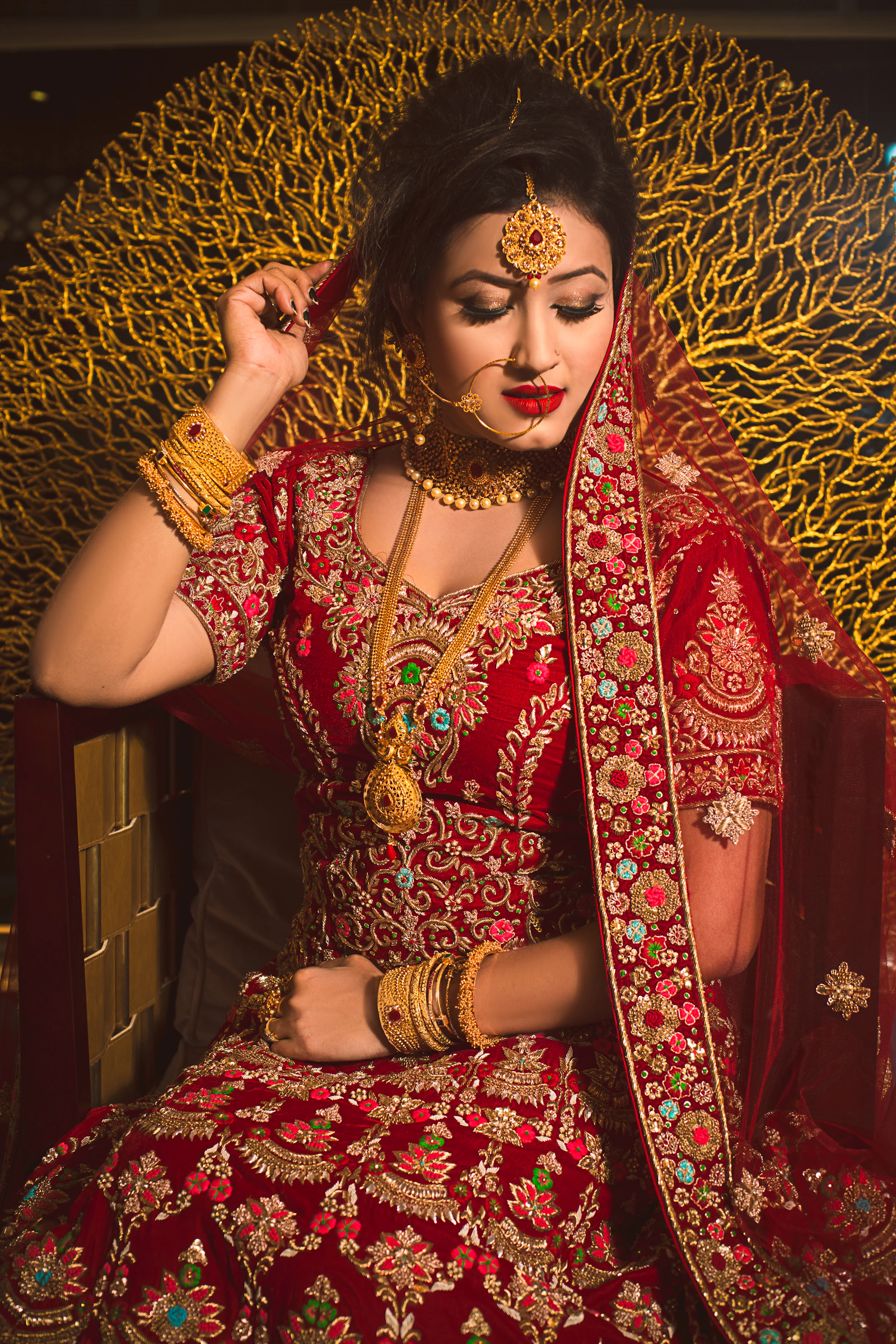 A bride in an embroidered bridal lehenga.