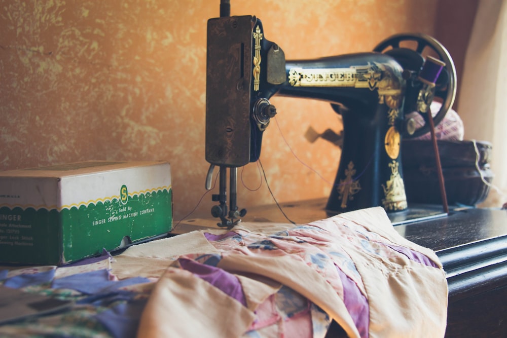 black sewing machine on white and pink floral textile