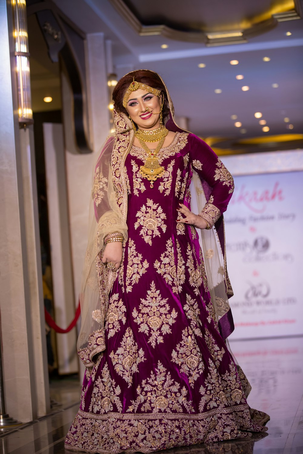 woman in purple and gold floral sari