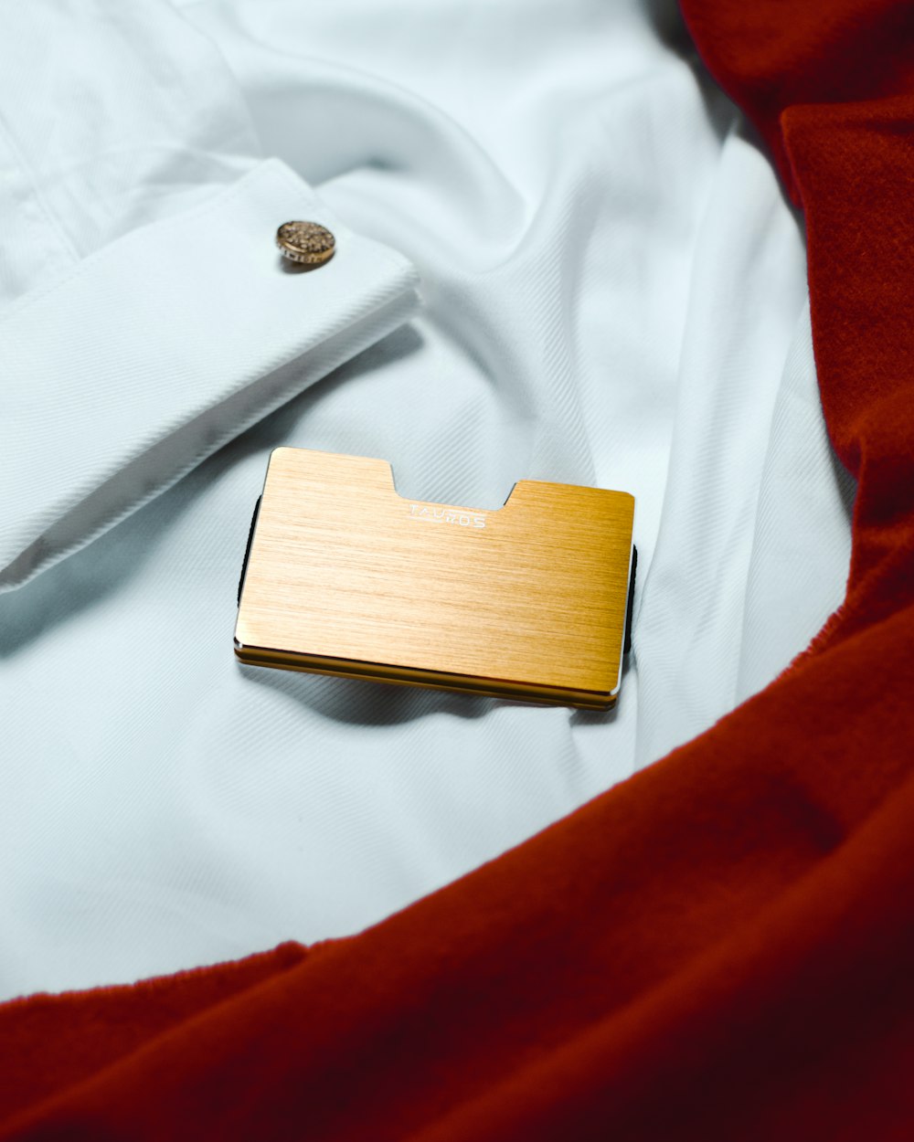 brown wooden box on white textile