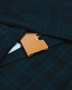 brown leather flip cover on blue and black plaid textile