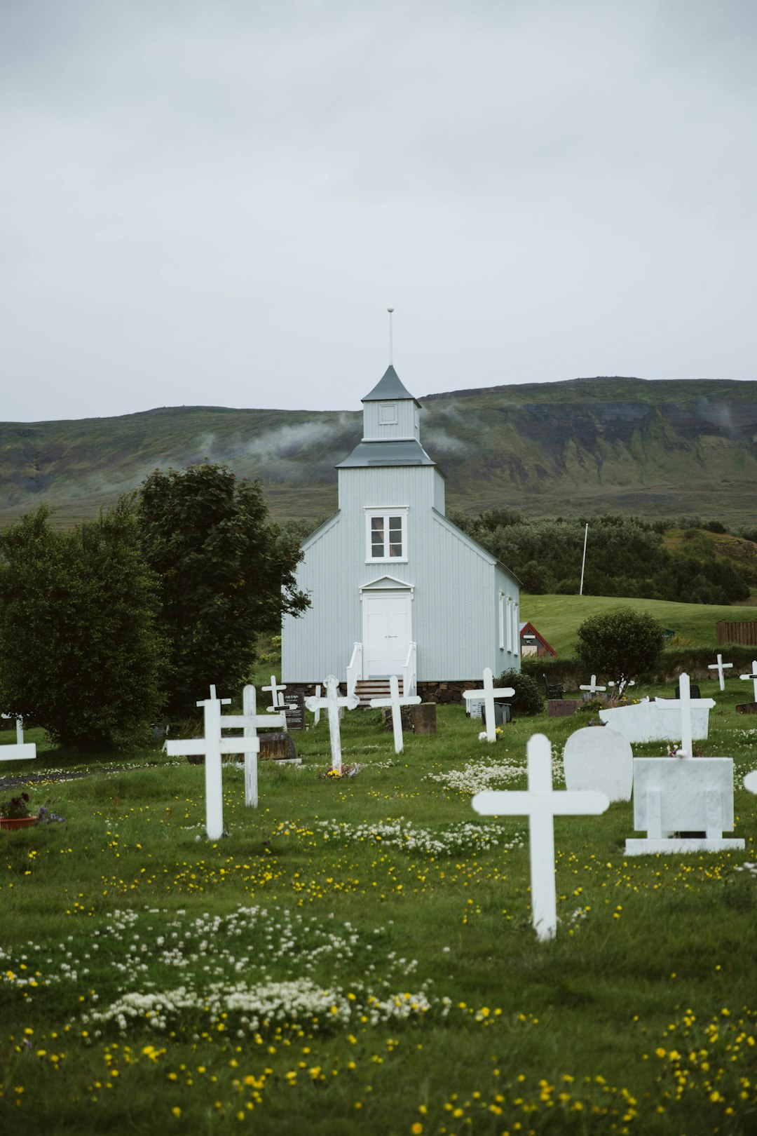 white church on green grass field during daytime